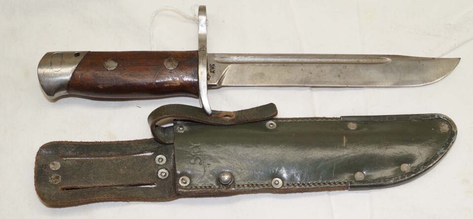 M1939 bayonet with green leather sheath.