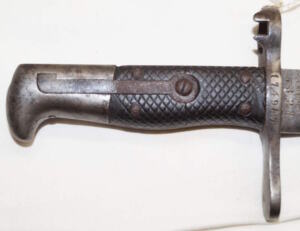 M1878 Vetterli sawback bayonet SJG NEUHAUSEN Grips cracked but remain tight.